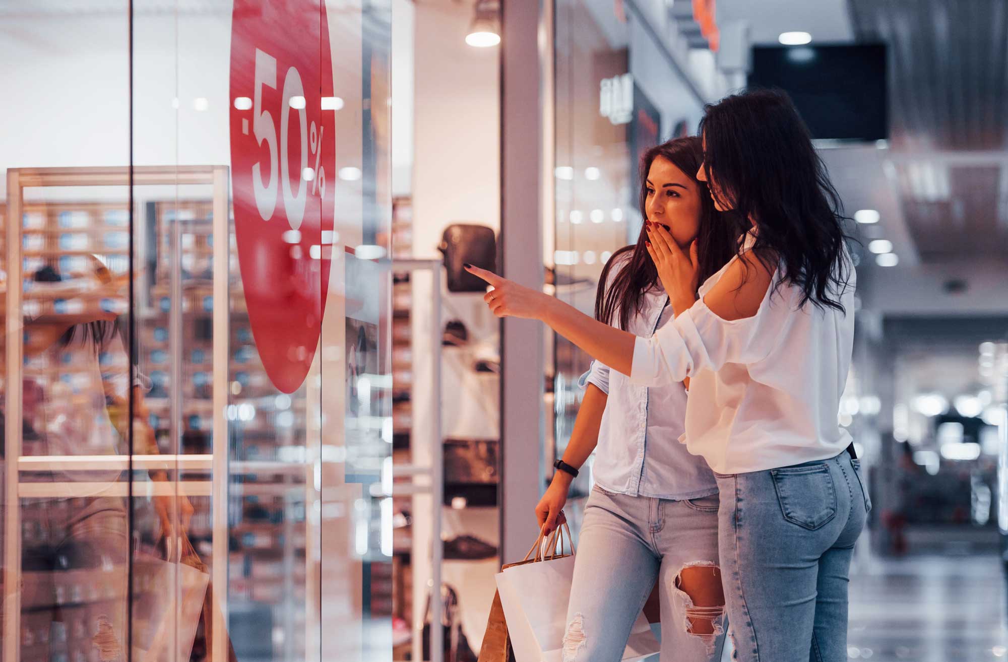 Feeling excited. Two young women have a shopping day together in the supermarket